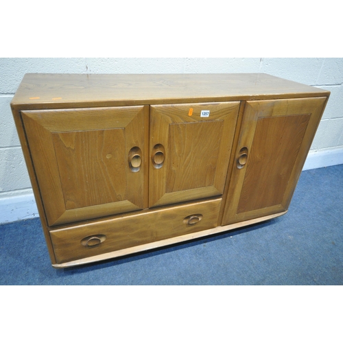 1257 - AN ERCOL BLONDE ELM SIDEBOARD, with double cupboard doors over a single drawer flanked by a single c... 