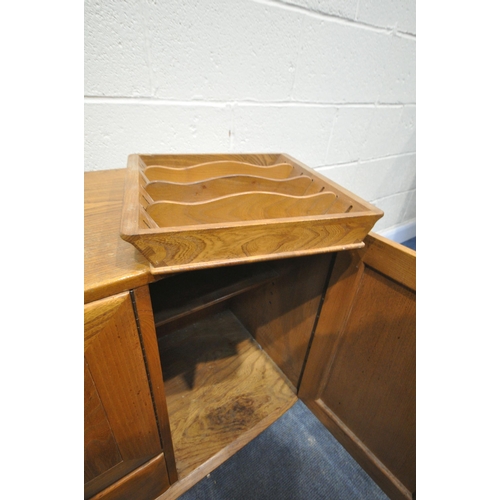 1257 - AN ERCOL BLONDE ELM SIDEBOARD, with double cupboard doors over a single drawer flanked by a single c... 