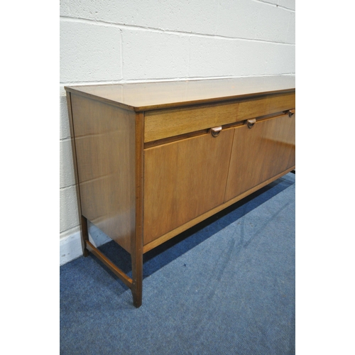 1266 - A MID CENTURY NATHAN SIDEBOARD, with three drawers, over cupboard doors flanking a fall front doors,... 