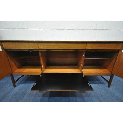 1266 - A MID CENTURY NATHAN SIDEBOARD, with three drawers, over cupboard doors flanking a fall front doors,... 