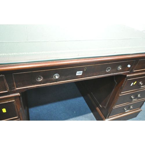 1291 - A 20TH CENTURY MAHOGANY TWIN PEDESTAL DESK, with a green and tooled leather writing surface, a glass... 