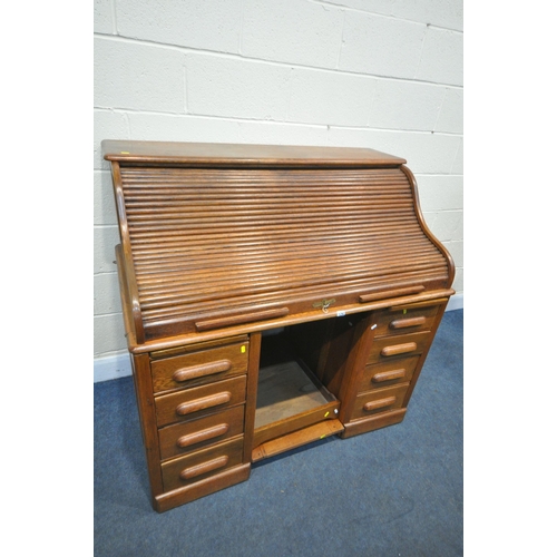 1292 - AN EARLY 20TH CENTURY OAK ROLL TOP DESK, with a fitted interior, over a base with a single drawer, a... 