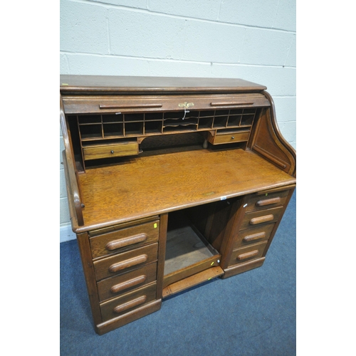 1292 - AN EARLY 20TH CENTURY OAK ROLL TOP DESK, with a fitted interior, over a base with a single drawer, a... 