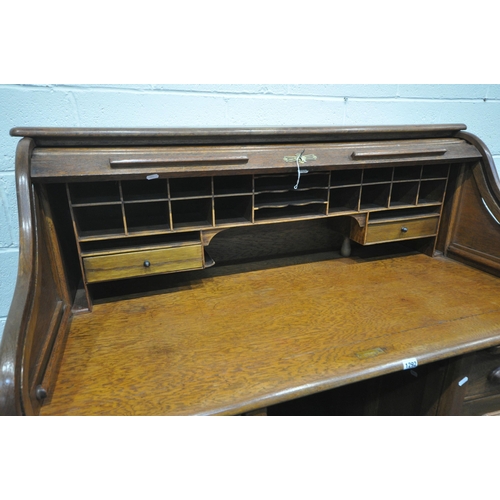 1292 - AN EARLY 20TH CENTURY OAK ROLL TOP DESK, with a fitted interior, over a base with a single drawer, a... 