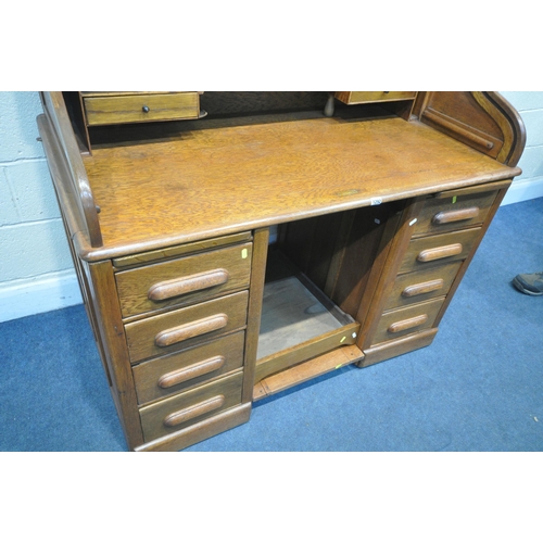 1292 - AN EARLY 20TH CENTURY OAK ROLL TOP DESK, with a fitted interior, over a base with a single drawer, a... 