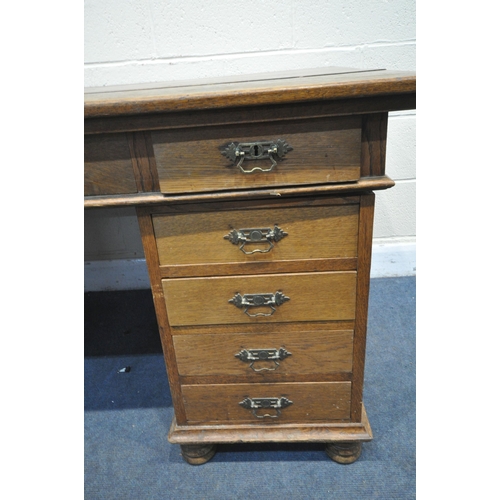 1316 - AN EARLY 20TH CENTURY OAK PEDESTAL DESK, with four frieze drawers, and four drawers to each pedestal... 