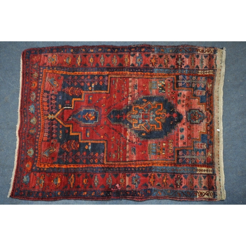 1328 - A 20TH CENTURY IRANIAN PATTERENED RED GROUND RUG, 175cm x 135cm