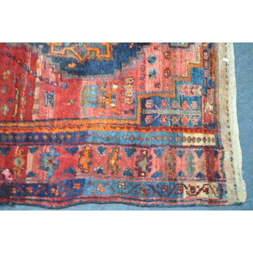 1328 - A 20TH CENTURY IRANIAN PATTERENED RED GROUND RUG, 175cm x 135cm