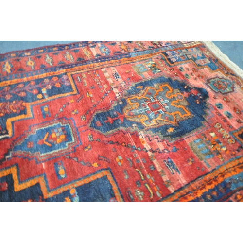 1328 - A 20TH CENTURY IRANIAN PATTERENED RED GROUND RUG, 175cm x 135cm