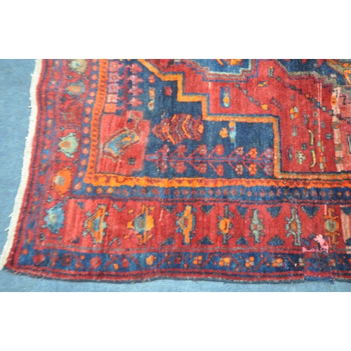 1328 - A 20TH CENTURY IRANIAN PATTERENED RED GROUND RUG, 175cm x 135cm