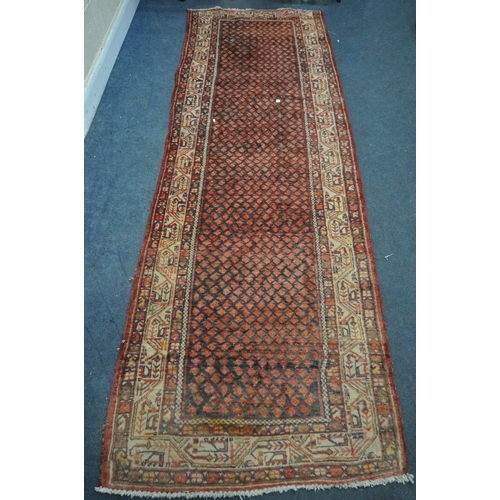 1330 - A 20TH CENTURY IRANIAN RED PATTERNED CARPET RUNNER, 319cm x105cm (condition:-some low pile)