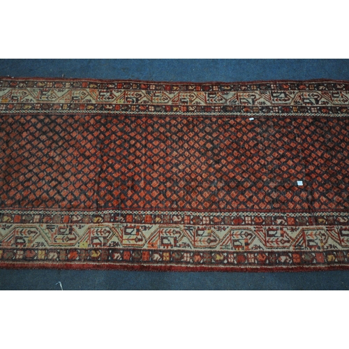 1330 - A 20TH CENTURY IRANIAN RED PATTERNED CARPET RUNNER, 319cm x105cm (condition:-some low pile)