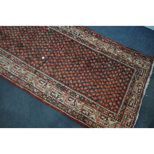 1330 - A 20TH CENTURY IRANIAN RED PATTERNED CARPET RUNNER, 319cm x105cm (condition:-some low pile)