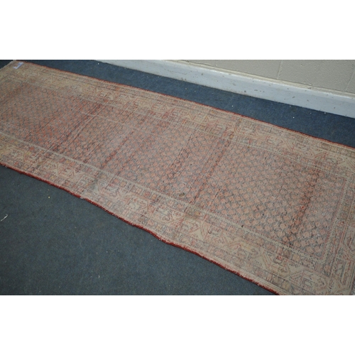 1330 - A 20TH CENTURY IRANIAN RED PATTERNED CARPET RUNNER, 319cm x105cm (condition:-some low pile)