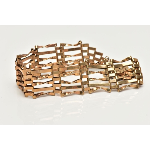 11 - A 9CT GOLD GATE BRACELET, six bar bracelet, fitted with a heart padlock clasp with additional safety... 