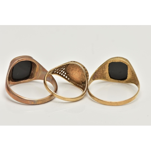 22 - THREE SIGNET RINGS, to include a polished onyx inlay signet ring, collet set in a yellow metal mount... 