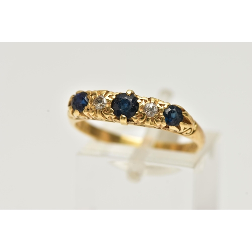 24 - A YELLOW METAL SAPPHIRE AND DIAMOND RING, designed with three circular cut deep blue sapphires, inte... 