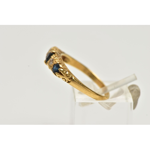 24 - A YELLOW METAL SAPPHIRE AND DIAMOND RING, designed with three circular cut deep blue sapphires, inte... 