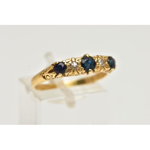 24 - A YELLOW METAL SAPPHIRE AND DIAMOND RING, designed with three circular cut deep blue sapphires, inte... 