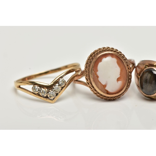 28 - FOUR RINGS, to include a shell cameo, depicting a lady in profile, collet set with a fine rope twist... 