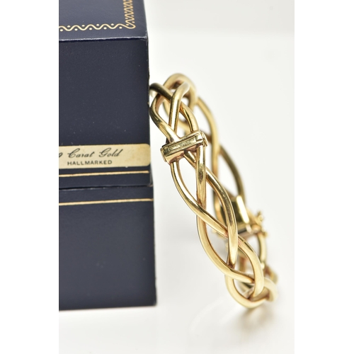 57 - A 9CT GOLD HINGED BANGLE, openwork weaved bangle, fitted with a push piece clasp and two figure of e... 