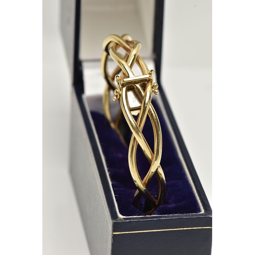 57 - A 9CT GOLD HINGED BANGLE, openwork weaved bangle, fitted with a push piece clasp and two figure of e... 