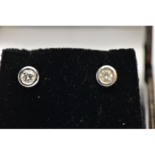 59 - A PAIR OF DIAMOND STUD EARRINGS, each collet set with a round brilliant cut diamond, each approximat... 