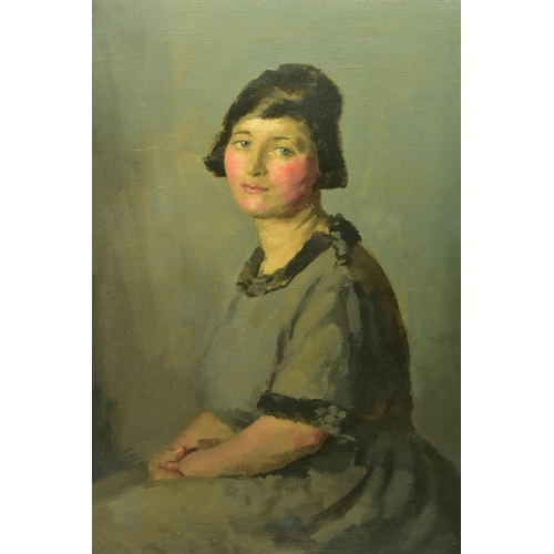 320 - JOHN WHEATLEY (1892-1955) A SEATED PORTRAIT OF A FEMALE FIGURE, she is gazing straight at the viewer... 