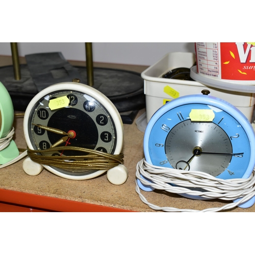 353 - A COLLECTION OF MID - CENTURY CLOCKS, comprising an Art Deco style arched mirrored electric clock ma... 