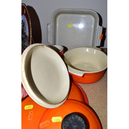 356 - A SET OF LE CREUSET BURNT ORANGE OVENWARE, comprising a 1.5 litre casserole (chipped lid), two ramek... 