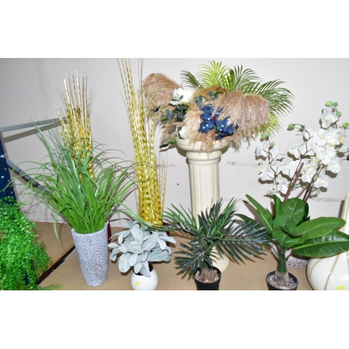 365 - A LARGE QUANTITY OF ARTIFICIAL PLANTS AND FLOWERS, to include a large green parrot figurine on a sta... 