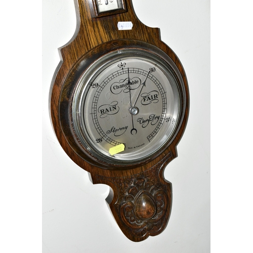 390 - A WALL CLOCK AND A BAROMETER, comprising a large wooden cased wall clock, back bears partial Jerome ... 