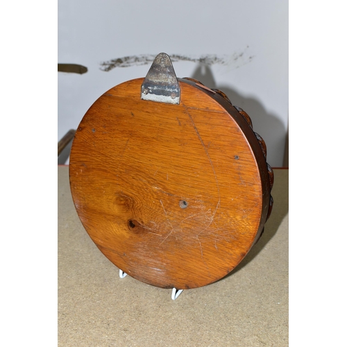 404 - A VICTORIAN CIRCULAR ANEROID BAROMETER, with a heavy carved wood case and frame in the form of rope,... 