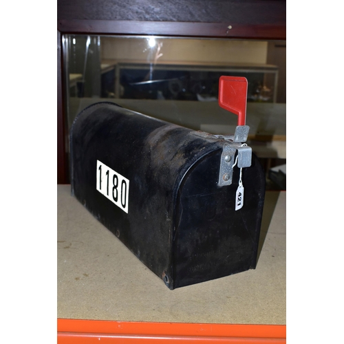 421 - AN AMERICAN MAIL BOX, painted black, with red flag, one end reading 'US Mail, approved by the Postma... 