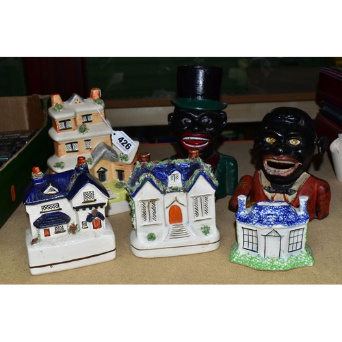 426 - A COLLECTION OF MONEY BOXES, comprising four ceramic Staffordshire/Staffordshire-style money boxes o... 