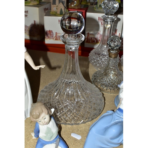 449 - A GROUP OF CUT CRYSTAL DECANTERS AND LLADRO FIURES, comprising a pair of Crystal d'Arques decanters,... 