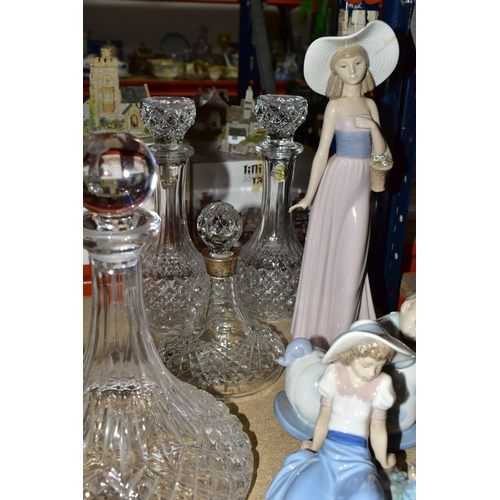 449 - A GROUP OF CUT CRYSTAL DECANTERS AND LLADRO FIURES, comprising a pair of Crystal d'Arques decanters,... 