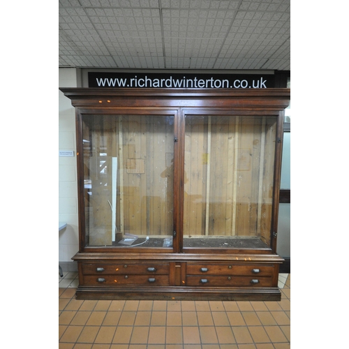 1329 - A LARGE LATE 19TH CENTURY MAHOGANY DISPLAY CABINET, overhanging cornice, fitted with two glazed door... 