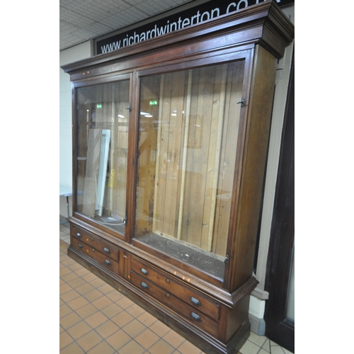 1329 - A LARGE LATE 19TH CENTURY MAHOGANY DISPLAY CABINET, overhanging cornice, fitted with two glazed door... 