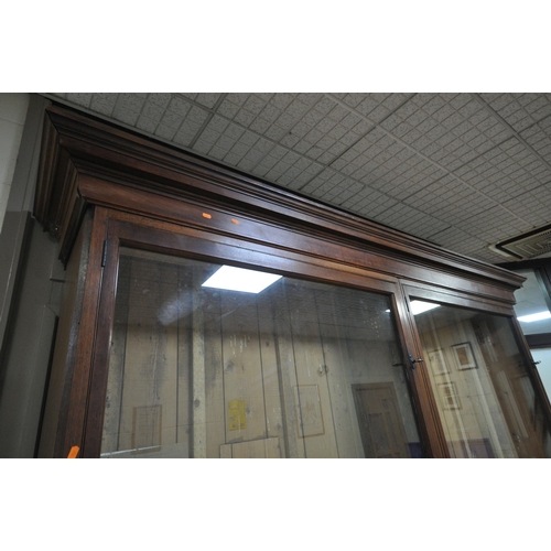 1329 - A LARGE LATE 19TH CENTURY MAHOGANY DISPLAY CABINET, overhanging cornice, fitted with two glazed door... 