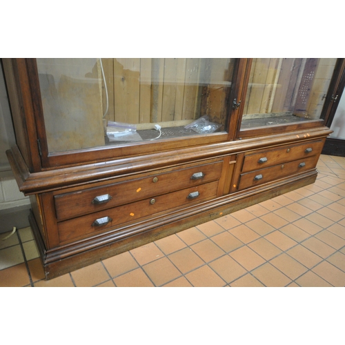 1329 - A LARGE LATE 19TH CENTURY MAHOGANY DISPLAY CABINET, overhanging cornice, fitted with two glazed door... 