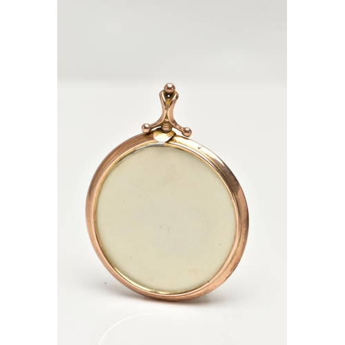 15 - A YELLOW METAL DOUBLE PHOTO LOCKET, of a circular form, polished case with a bead detailed bail, sta... 