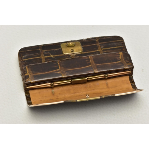 28 - AN EARLY 20TH CENTURY CROCODILE SKIN PURSE, mounted with two 9ct rose gold hard wear corners to the ... 