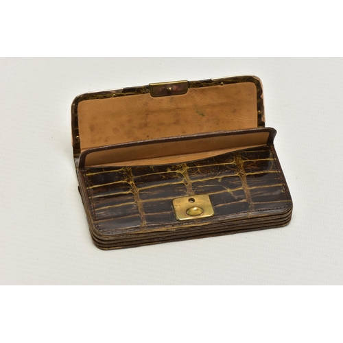 28 - AN EARLY 20TH CENTURY CROCODILE SKIN PURSE, mounted with two 9ct rose gold hard wear corners to the ... 