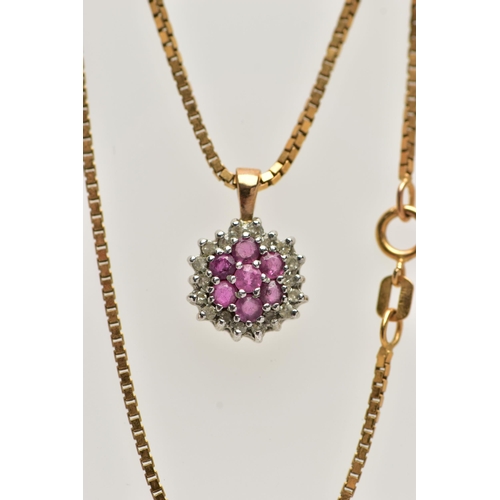 31 - A 9CT GOLD RUBY AND DIAMOND PENDANT, seven circular cut rubies, prong set with a surround of round b... 