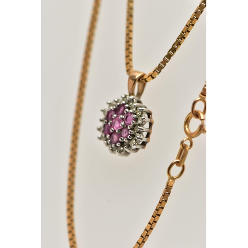 31 - A 9CT GOLD RUBY AND DIAMOND PENDANT, seven circular cut rubies, prong set with a surround of round b... 