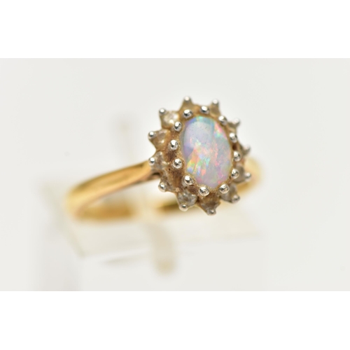 40 - A 18CT GOLD OPAL CLUSTER RING, a single cabochon set with a surround of round brilliant cut diamonds... 