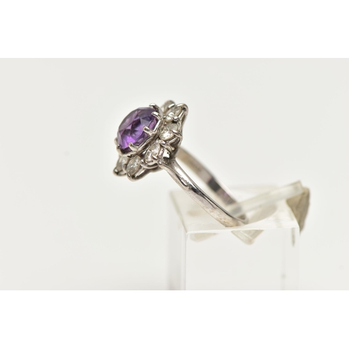 58 - AN AMETHYST AND DIAMOND CLUSTER RING, set with a principal amethyst, measuring approximately 8.08 x ... 