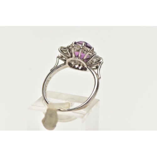 58 - AN AMETHYST AND DIAMOND CLUSTER RING, set with a principal amethyst, measuring approximately 8.08 x ... 