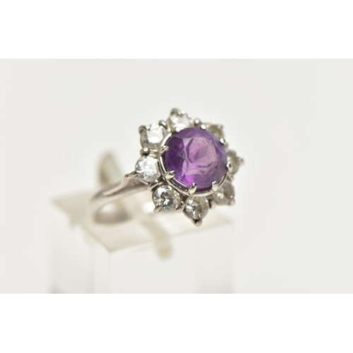 58 - AN AMETHYST AND DIAMOND CLUSTER RING, set with a principal amethyst, measuring approximately 8.08 x ... 